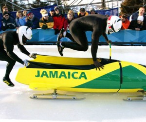 Lascelles Oneil Brown (L) and Winston Alexander Watt of the Jamaica-1 team leap into their sled at the start of heat three of the two-man bobsleigh competition at the Salt Lake 2002 Winter Olympic Games, February 17, 2002 in Park City (Reuters/Peter Andrews)