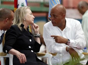 Former U.S. Secretary of State Hillary Clinton speaks with Haitian President Michel Martelly (R).