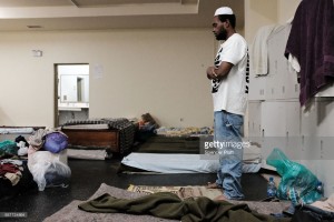 Collen Harris, a practicing Muslim and a displaced resident from the island of Barbuda, prays inside a shelter at a cricket stadium on December 7, 2017 in St John's, Antigua.
