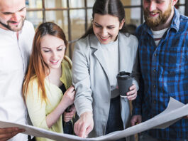 happy-coworkers-working-blue-print-office