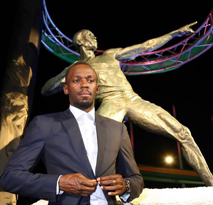 usain-bolt-with-jamaica-statue