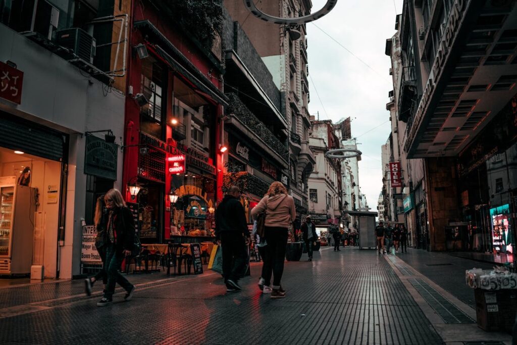 people walking between buildings on a street in Buenos Aires, Argentina