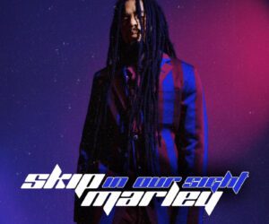 Skip Marley, Alaine, Sean Paul & More Deliver New Caribbean Music This New Music Friday Skip Marley poses in a bold striped suit on a purple and red background to promote the release of his new single “In Our Sight” and official video, filmed in Jamaica.