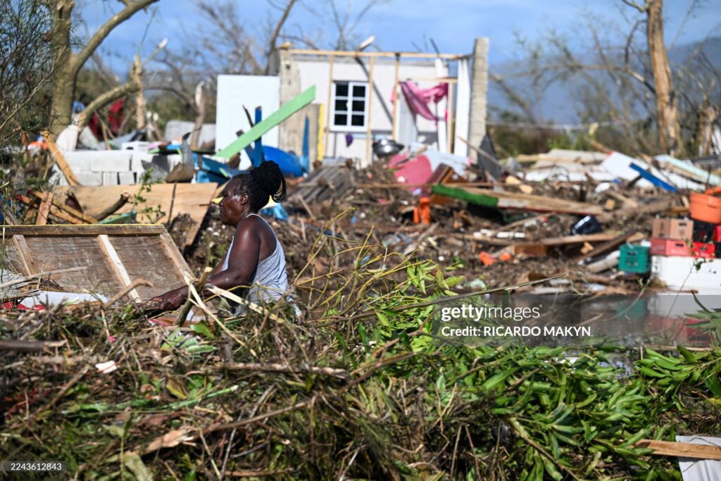 a-woman-clears-debris-after-hurricane-melissa-ruined-her-home-st-elizabeth-jamaica