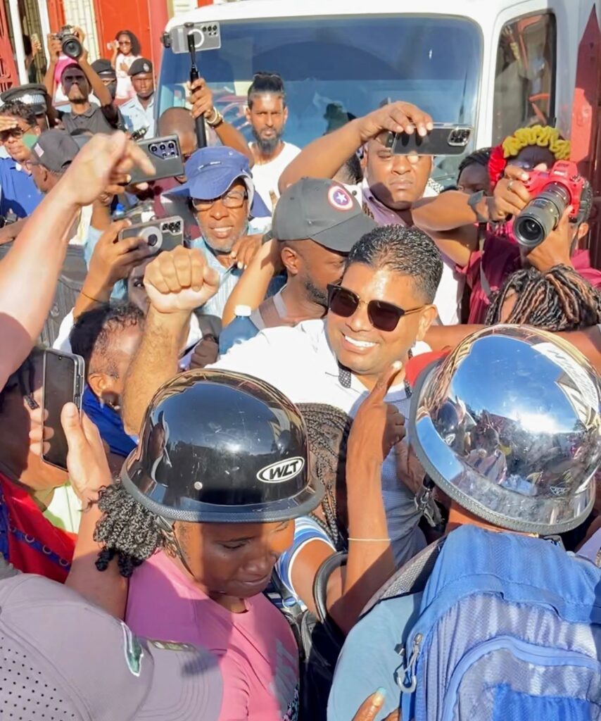 Guyana Opposition leader embraced by supporters after court appearance. 