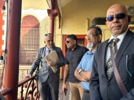 Extradition Hearing For US-Indicted Guyanese MP And Next Opposition Leader -Azruddin Mohamed – Set to Resume Next Year Azruddin Mohamed stands with his lawyers outside the Georgetown Magistrates’ Court during his ongoing US extradition proceedings.
