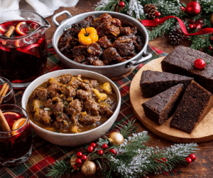 Caribbean Christmas Foods: Traditional Recipes And Cultural History n the Caribbean, Christmas food is not simply what’s eaten—it’s how the holiday is felt. Food sits at the center of family life, cultural memory, and community connection, turning Christmas into a shared experience that goes far beyond the table. From the moment hams are ordered and fruits are soaked in rum, the season begins. Kitchens become gathering spaces where multiple generations come together, passing down recipes, stories, and unspoken traditions. Preparing food is a communal act—one that strengthens family bonds and reinforces a sense of belonging. Traditional dishes carry deep cultural meaning. Caribbean Christmas meals reflect African, Indigenous, and European influences layered over centuries, making each dish a living record of survival and adaptation. Foods like pastelles, garlic pork, pepperpot, and black cake are more than seasonal favorites—they are edible heritage, connecting present-day celebrations to ancestral kitchens. Hospitality is another reason food matters so deeply. Caribbean Christmas tables are intentionally abundant. There is always extra food, extra drink, and room for one more guest. Visitors are expected to eat, to be nourished, and to feel at home. Generosity is measured not by portions but by openness. The sensory experience seals it all. The scent of baking spices, simmering meats, fresh ginger, cloves, and rum fills homes for days. Music plays—parang, carols, or soca—and the kitchen hums with movement. These sights, sounds, and aromas create a Christmas atmosphere that is instantly recognizable to anyone raised in the Caribbean. Christmas meals are rarely rushed. They follow church services, family visits, and long conversations, stretching from midday into evening, with leftovers lasting for days. In this way, food extends the celebration itself, turning Christmas into a season rather than a single moment. In the Caribbean, food at Christmas is love made visible. It is memory served warm, culture shared generously, and tradition kept alive—one plate at a time.
