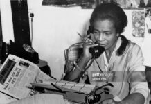 Unsung Caribbean Heroes You Didn’t Learn About in School Claudia Jones, Trinidad-born journalist and activist, working at her desk while advocating for Black rights and Caribbean communities in the diaspora.