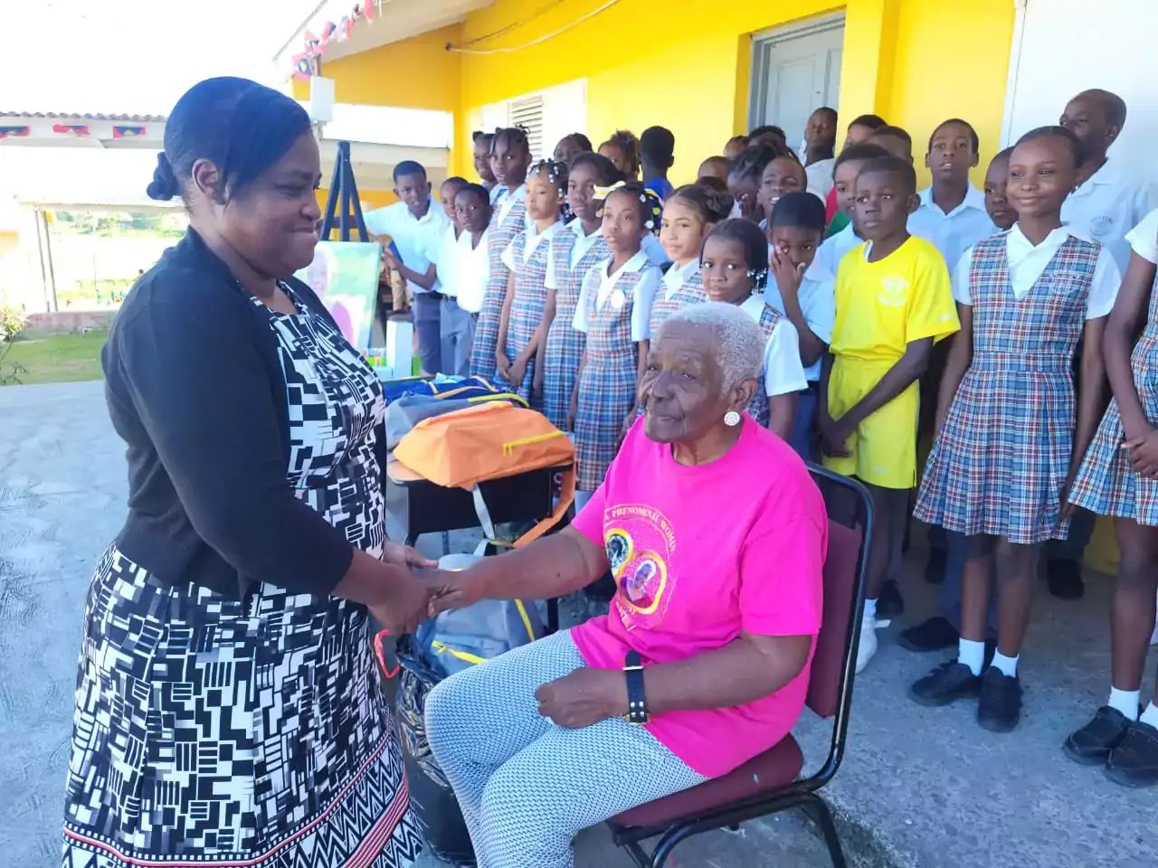Teacher Gen Honored in Potters Village Ceremony Retired Antiguan educator Teacher Gen being honored at Potters Village as students and community members look on.
