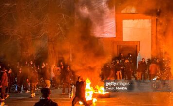 Iranians gather while blocking a street during a protest in Tehran, Iran on January 9, 2026. The nationwide protests started in Tehran's Grand Bazaar against the failing economic policies in late December, which spread to universities and other cities, and included economic slogans, to political and anti-government ones. (Photo by MAHSA / Middle East Images / AFP via Getty Images)