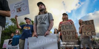 Demonstrators protest against Immigration and Customs Enforcement (ICE) and demanding the closure of the immigrant detention center known as "Alligator Alcatraz" outside the center at the Dade-Collier Training and Transition Airport in Ochopee, Florida, on January 11, 2026. A US Immigration and Customs Enforcement (ICE) agent shot and killed 37-year-old Renee Nicole Good on the streets of Minneapolis on January 7, leading to huge protests and outrage from local leaders who rejected White House claims she was a domestic terrorist.
