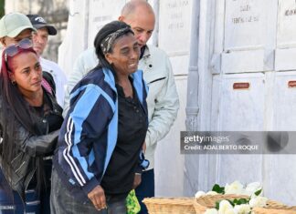 Relatives of some of the 32 Cuban soldiers killed during the US incursion in Venezuela pay respects at their graves during their funeral at Colon cemetery in Havana on January 16, 2026. The capture by US forces of Venezuelan leader Nicolas Maduro on January 3, 2026, and the killing in the operation of 32 Cubans assigned to protect him represent a major blow for the island's revered intelligence services, experts say.