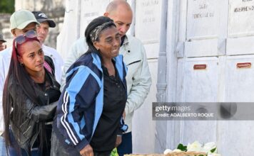 Relatives of some of the 32 Cuban soldiers killed during the US incursion in Venezuela pay respects at their graves during their funeral at Colon cemetery in Havana on January 16, 2026. The capture by US forces of Venezuelan leader Nicolas Maduro on January 3, 2026, and the killing in the operation of 32 Cubans assigned to protect him represent a major blow for the island's revered intelligence services, experts say.
