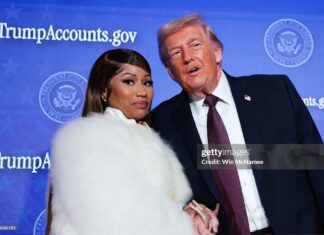 Musician Nicki Minaj (L) joins U.S. President Donald Trump on stage as he delivers remarks during the Treasury Department's Trump Accounts Summit at Andrew W. Mellon Auditorium on January 28, 2026 in Washington, DC. "Trump Accounts" are a portion of recently passed tax and spending legislation where the federal government will deposit $1,000 into investment accounts for every child born between 2025 and 2028 once parents sign their children up while filing their income taxes.  (Photo by Win McNamee/Getty Images)