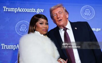 Musician Nicki Minaj (L) joins U.S. President Donald Trump on stage as he delivers remarks during the Treasury Department's Trump Accounts Summit at Andrew W. Mellon Auditorium on January 28, 2026 in Washington, DC. "Trump Accounts" are a portion of recently passed tax and spending legislation where the federal government will deposit $1,000 into investment accounts for every child born between 2025 and 2028 once parents sign their children up while filing their income taxes.  (Photo by Win McNamee/Getty Images)