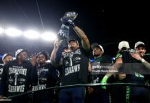 Elijah Arroyo #18 of the Seattle Seahawks lifts the Vince Lombardi Trophy after the NFL Super Bowl LX football game against the New England Patriots, at Levi's Stadium on February 8, 2026 in Santa Clara, CA.The Seattle Seahawks defeated the New England Patriots 29-13.