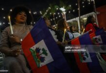 People attend a candlelight vigil for Haitians living in the US under the Temporary Protected Status (TPS) immigration program in Miami, Florida on February 3, 2026. Late on February 2, federal judge Ana C. Reyes of the Federal District Court in Washington, blocked the Trump administration from ending TPS for an estimated 350,000 Haitian immigrants. The status, which offers protection from deportation and work authorization, was set to expire on Feb. 3. 2026