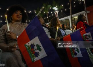 People attend a candlelight vigil for Haitians living in the US under the Temporary Protected Status (TPS) immigration program in Miami, Florida on February 3, 2026. Late on February 2, federal judge Ana C. Reyes of the Federal District Court in Washington, blocked the Trump administration from ending TPS for an estimated 350,000 Haitian immigrants. The status, which offers protection from deportation and work authorization, was set to expire on Feb. 3. 2026