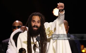 Jamaican musician Keznamdi accepts the Grammy for Best Reggae Album for "BLXXD & FYAH" on stage during the 68th Annual Grammy Awards Premiere Ceremony at the Crypto.com Arena in Los Angeles on February 1, 2026.