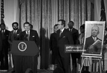 FLASHBACK - Late Republican President Ronald Reagan unveils postage stamp of Carter Woodson (father of black history) at a White House Ceremony marking the observance of National Afro-American (Black) History Month, Washington DC, February 2, 1984.