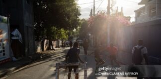 Caribbean Ingenuity In Pictures: How Haiti & Cuba Are Adapting Through Crisis Young boys play football with makeshift gear in Delmas, Port-au-Prince, Haiti, on March 22, 2026.