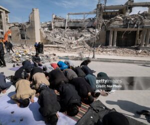 A group of Iranian men prays in an area that is targeted in U.S.-Israeli attacks in Tehran, Iran, on March 4, 2026.
