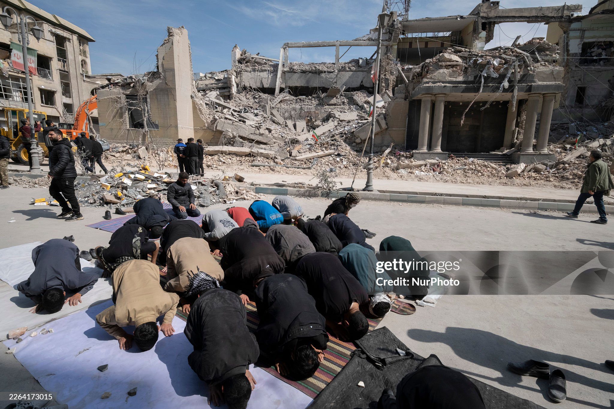 iranians-pray-near-bombed-site-in-tehran A group of Iranian men prays in an area that is targeted in U.S.-Israeli attacks in Tehran, Iran, on March 4, 2026.